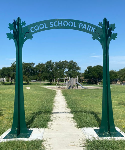 Gates with saying "Cool School Park" . tree planting initiatives