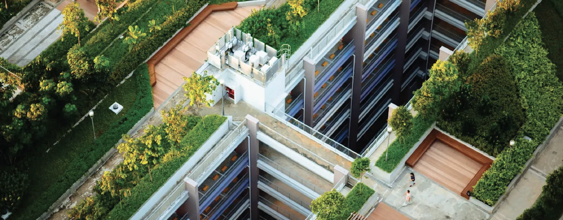 Aerial view of a commercial building with green roofs, landscaped terraces, and urban vegetation, illustrating biodiversity efforts aligned with GRESB 2025 standards.