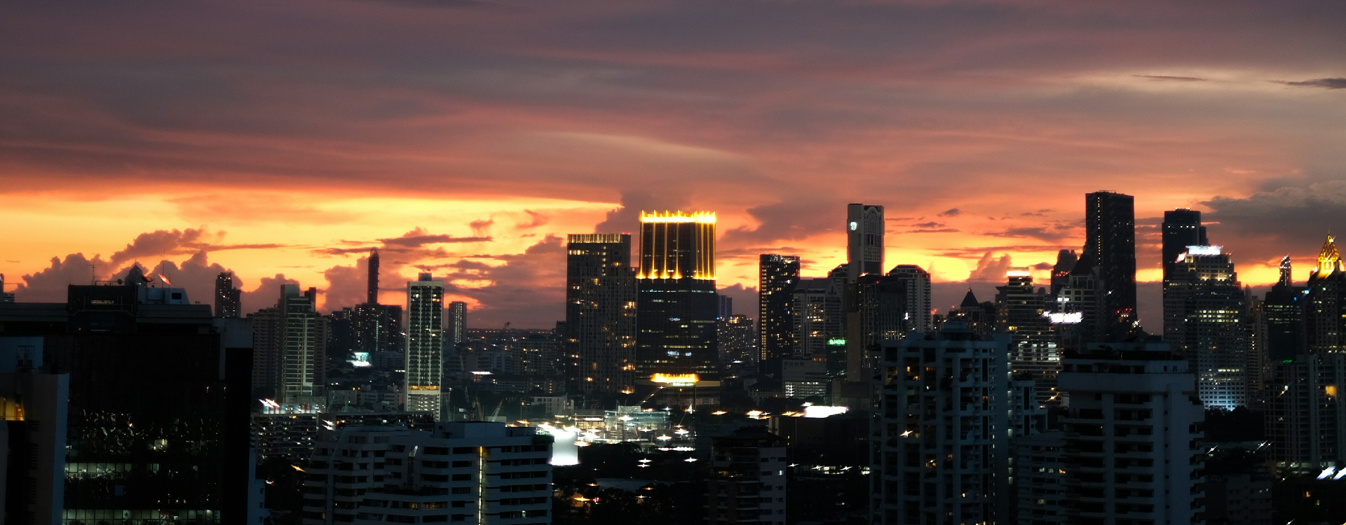 A modern city skyline with multiple office towers.